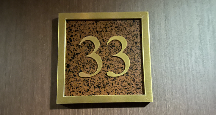 The number 33 on the floor sign during the apartment viewing